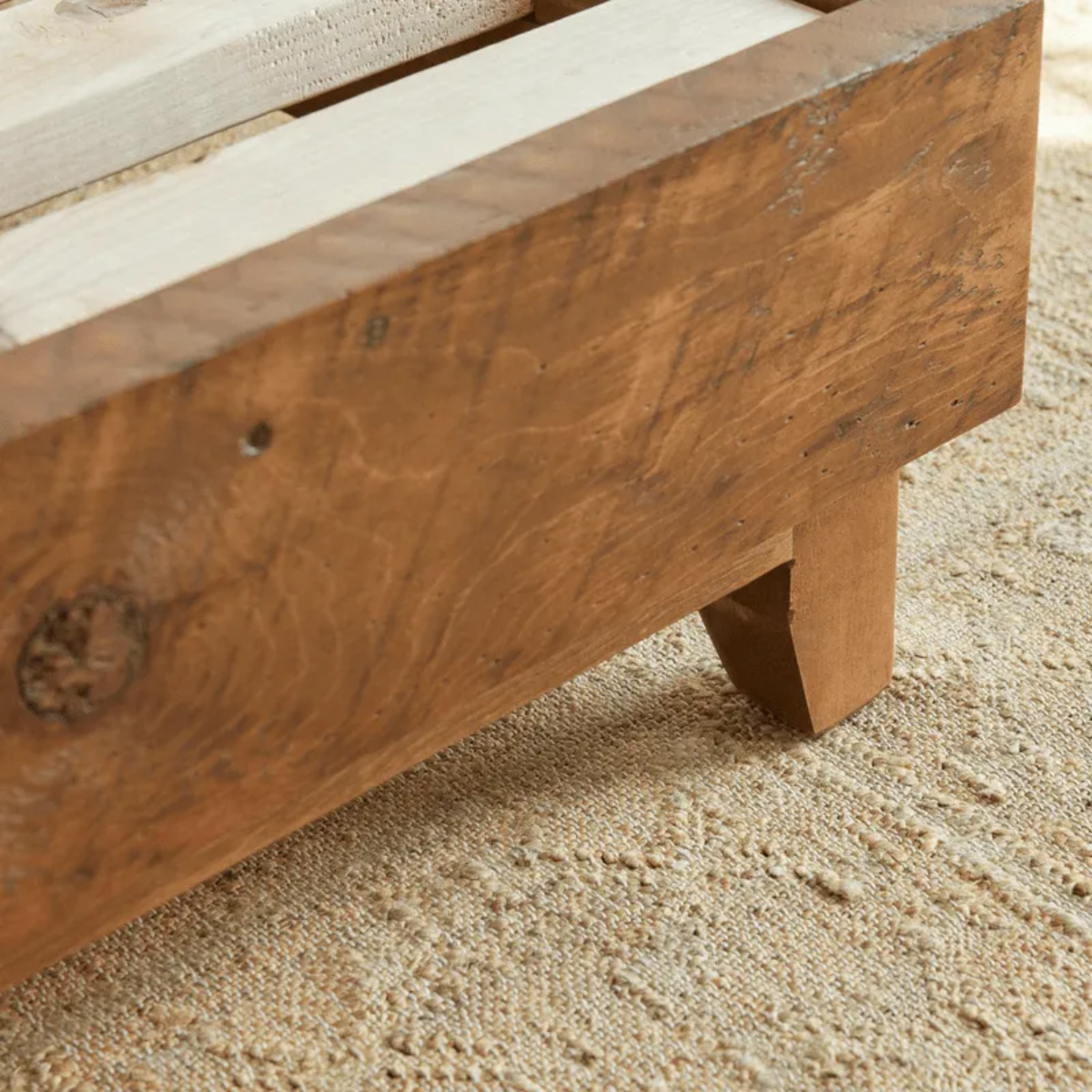Close-up of Avocado’s natural wood bed frame.