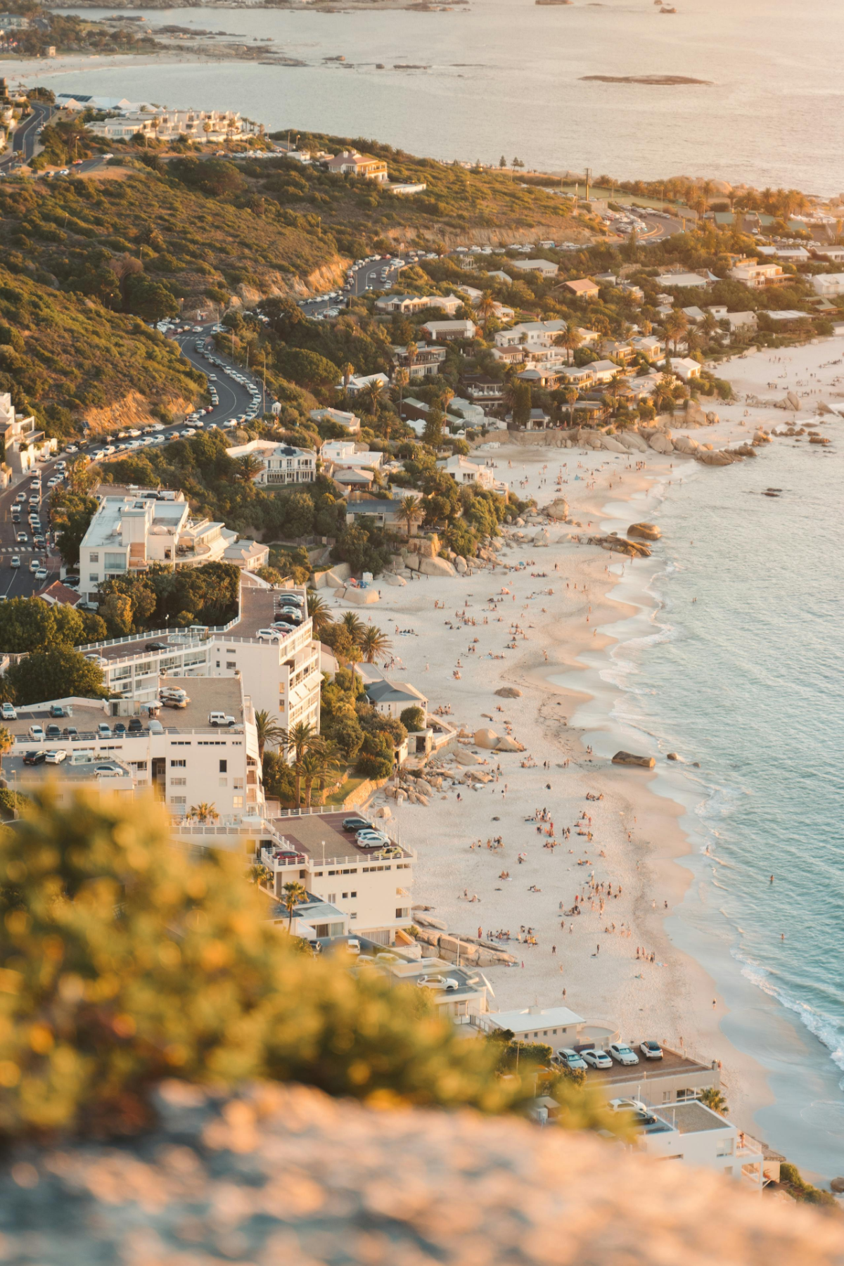 Close-up aerial of beachgoers enjoying the golden sands of Clifton Beach in Cape Town.