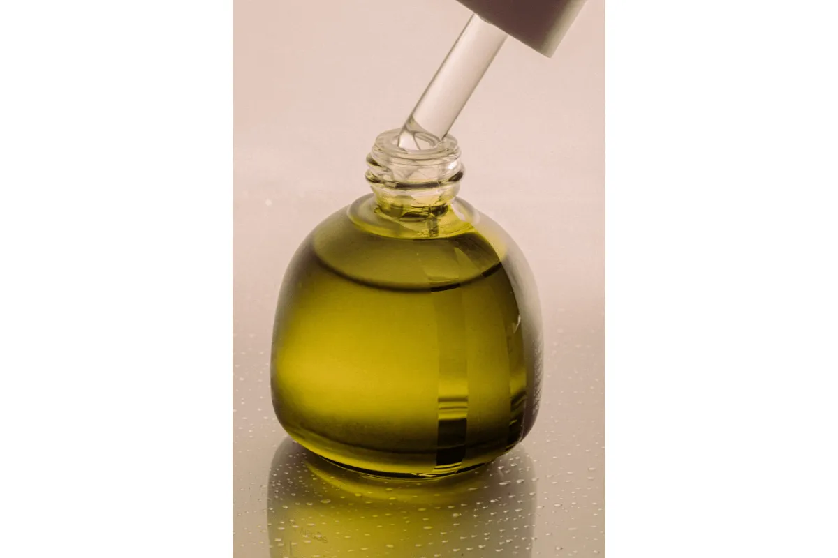 Green-hued glass bottle with dropper.