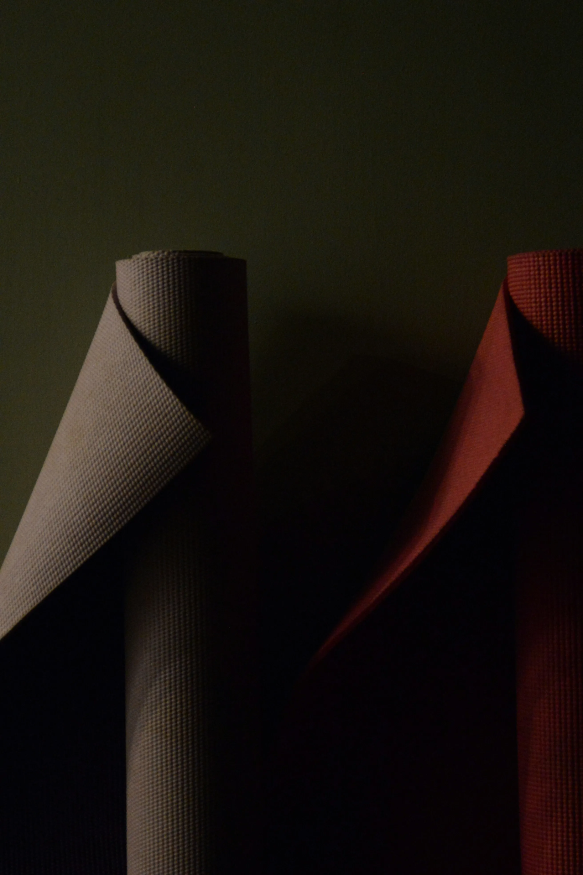 Rolled black and red yoga mats.