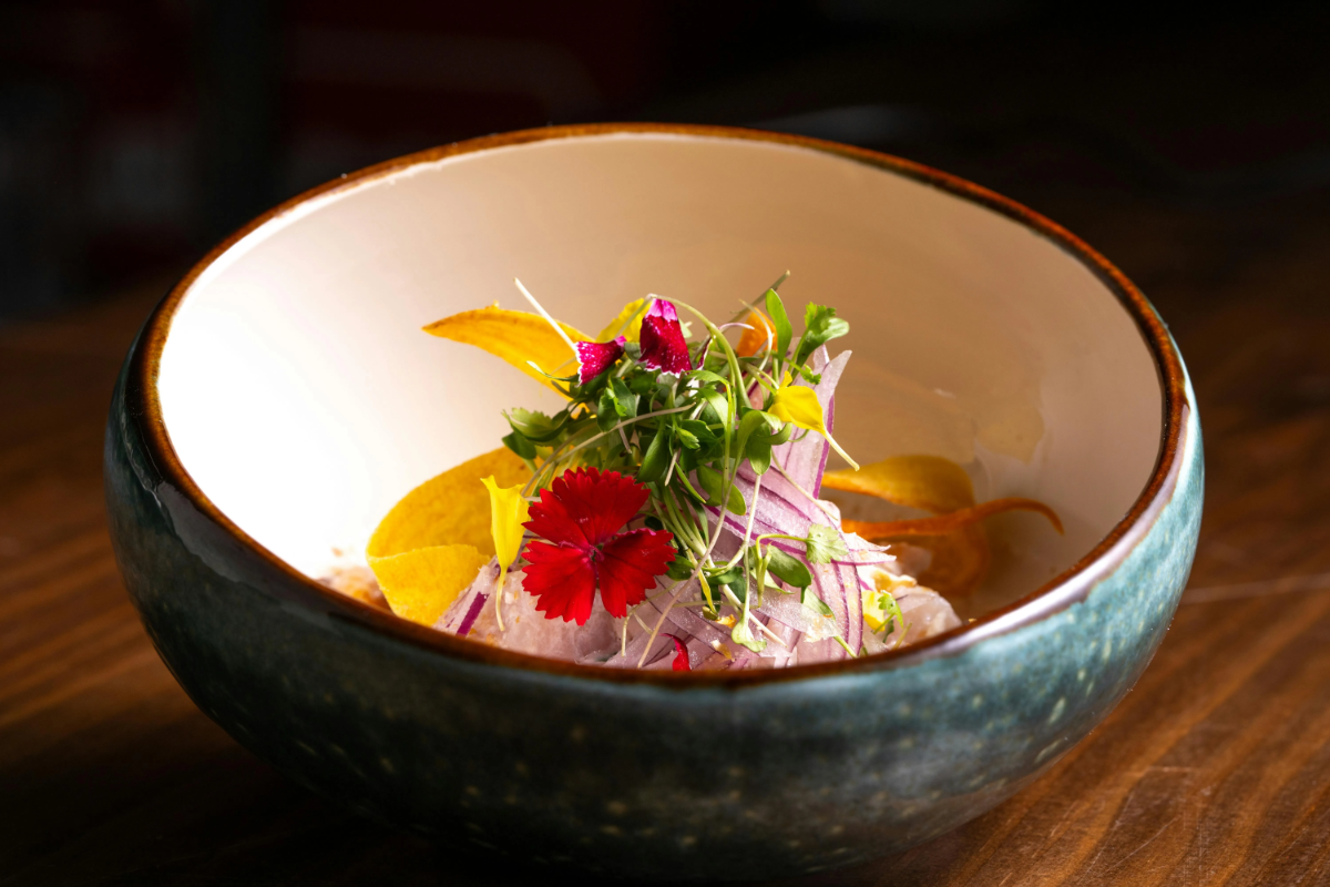 Colorful Peruvian ceviche in a ceramic bowl.