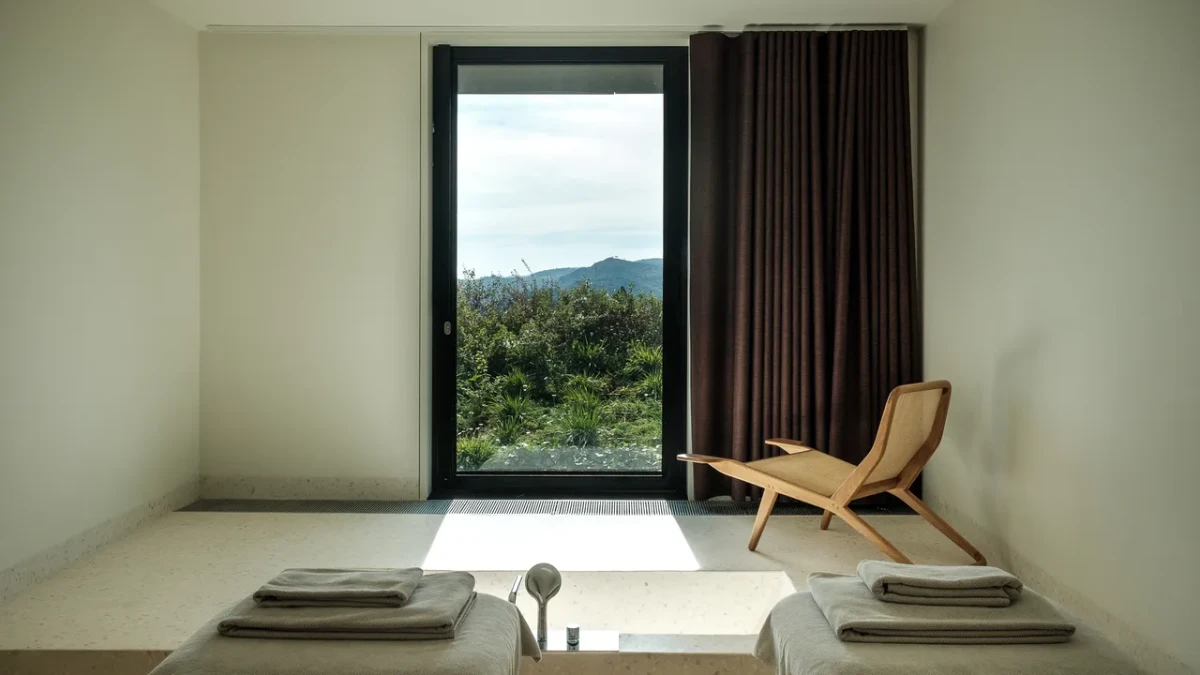 Casa de São Lourenço spa bath with minimalist interior and mountain views through large window