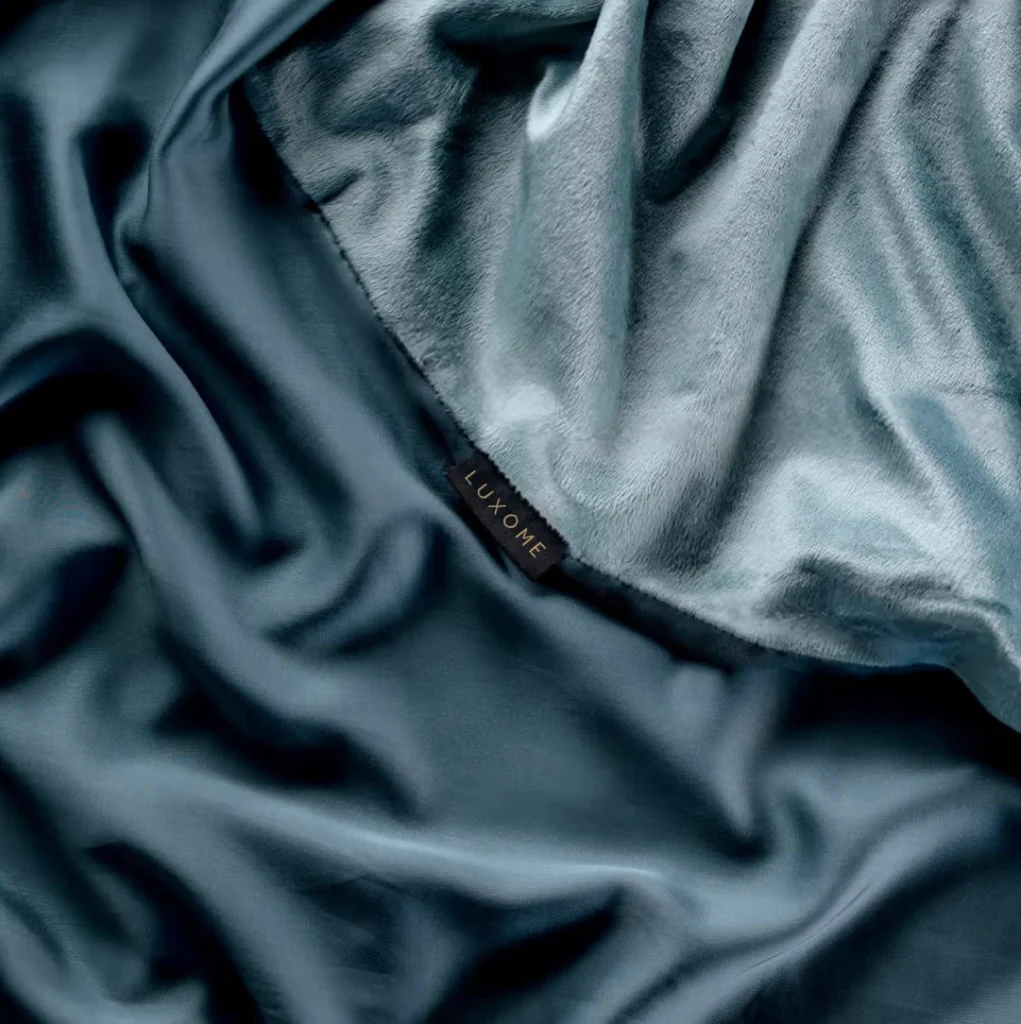 Luxome weighted blanket in soft blue fabric with smooth finish and gentle drape