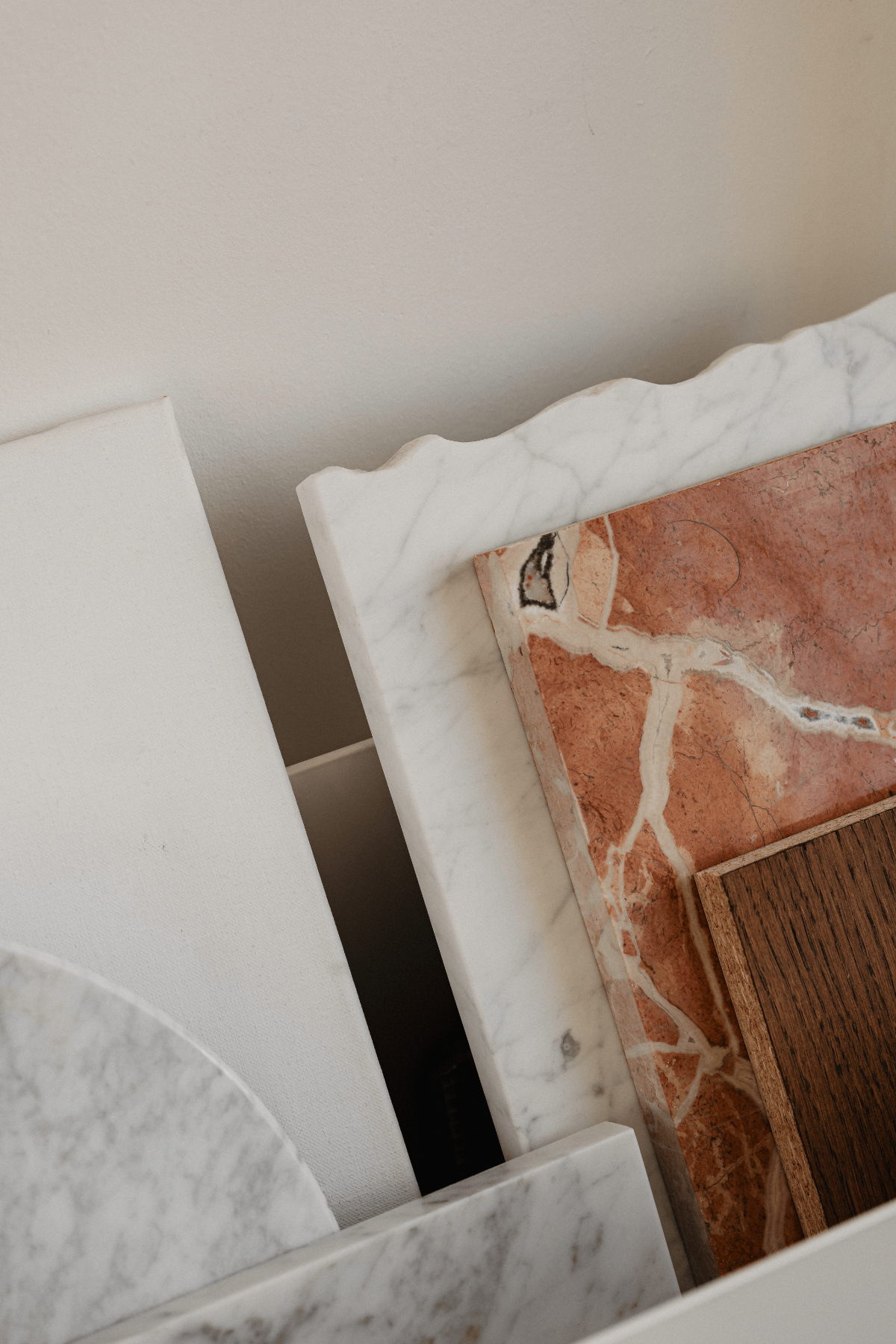 Assorted white and red marble slabs with rich veining, showcasing premium stone textures for countertops.