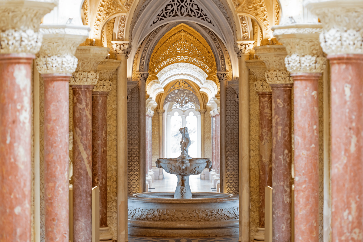 Intricate Moorish gallery of Monserrate Palace with marble fountain, gilded arches and rose marble columns in Sintra.