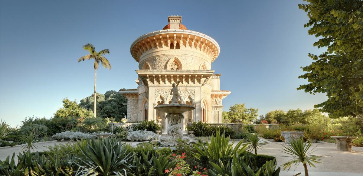 Exotic Neo-Moorish Monserrate Palace crowned by red dome, with lush botanical gardens and central fountain.