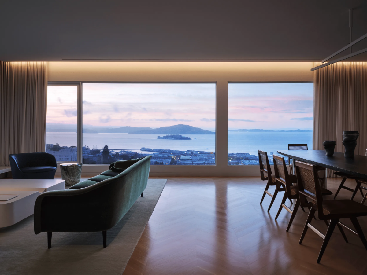 Studio Collins Weir living–dining room with bay view of Alcatraz at dusk, Russian Hill, San Francisco.