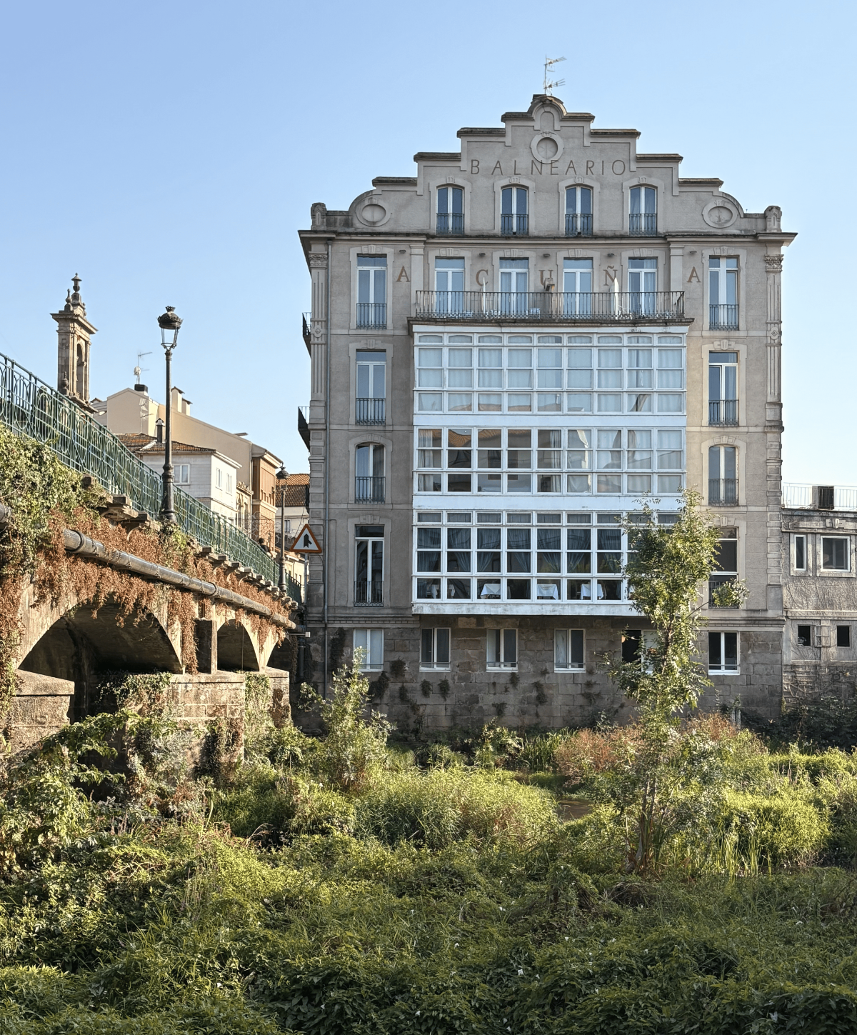 Historic Balneario Acuña spa building with central glass-fronted gallery in Caldas de Reis.