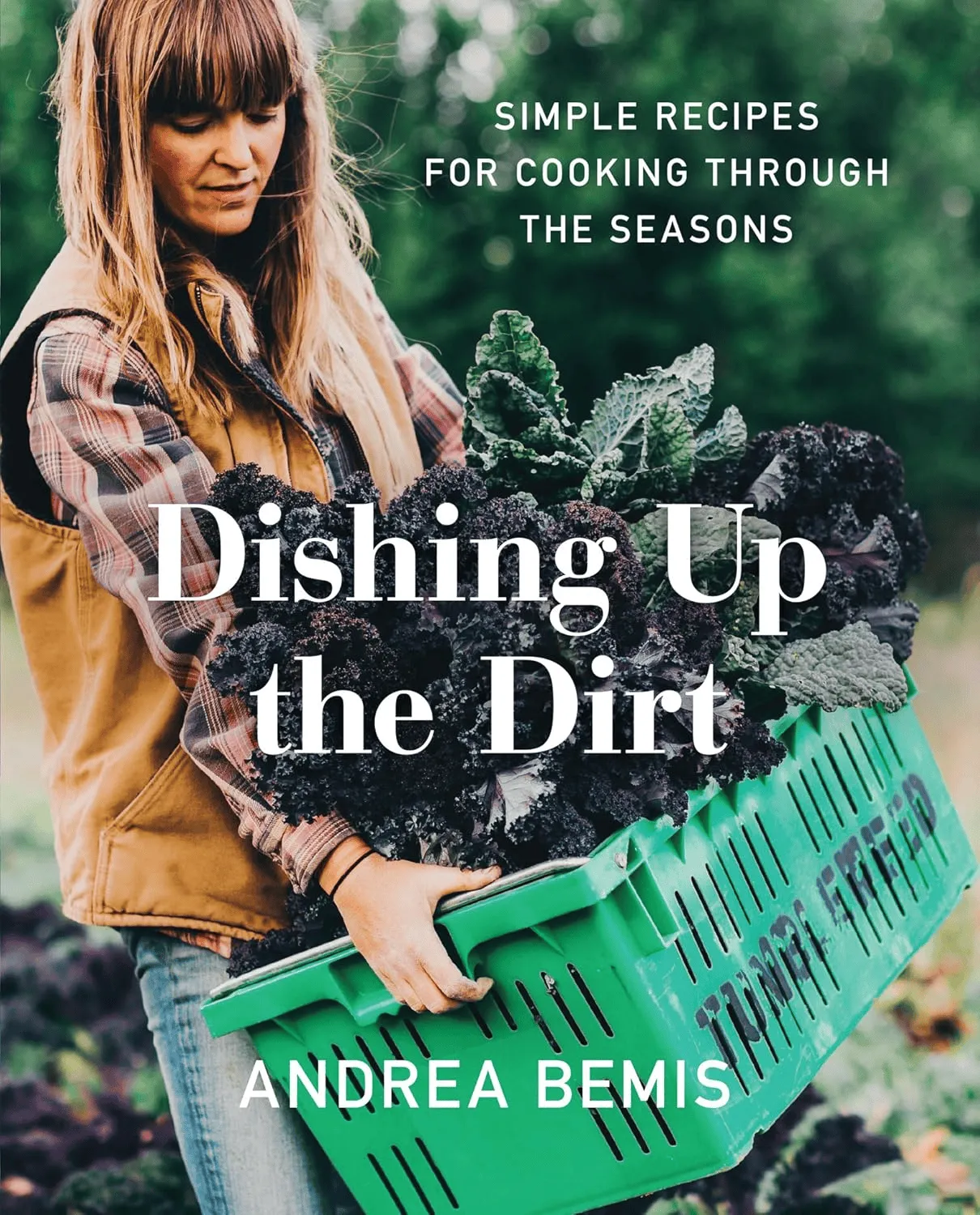 “Dishing Up the Dirt” cookbook cover showing farmer Andrea Bemis holding crate of freshly harvested kale in field.