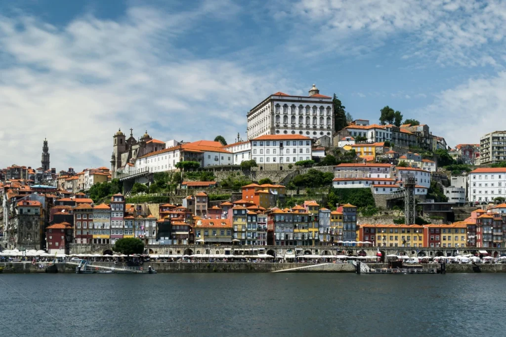 Colorful Ribeira waterfront in Porto along the Douro River with historic buildings and terracotta roofs