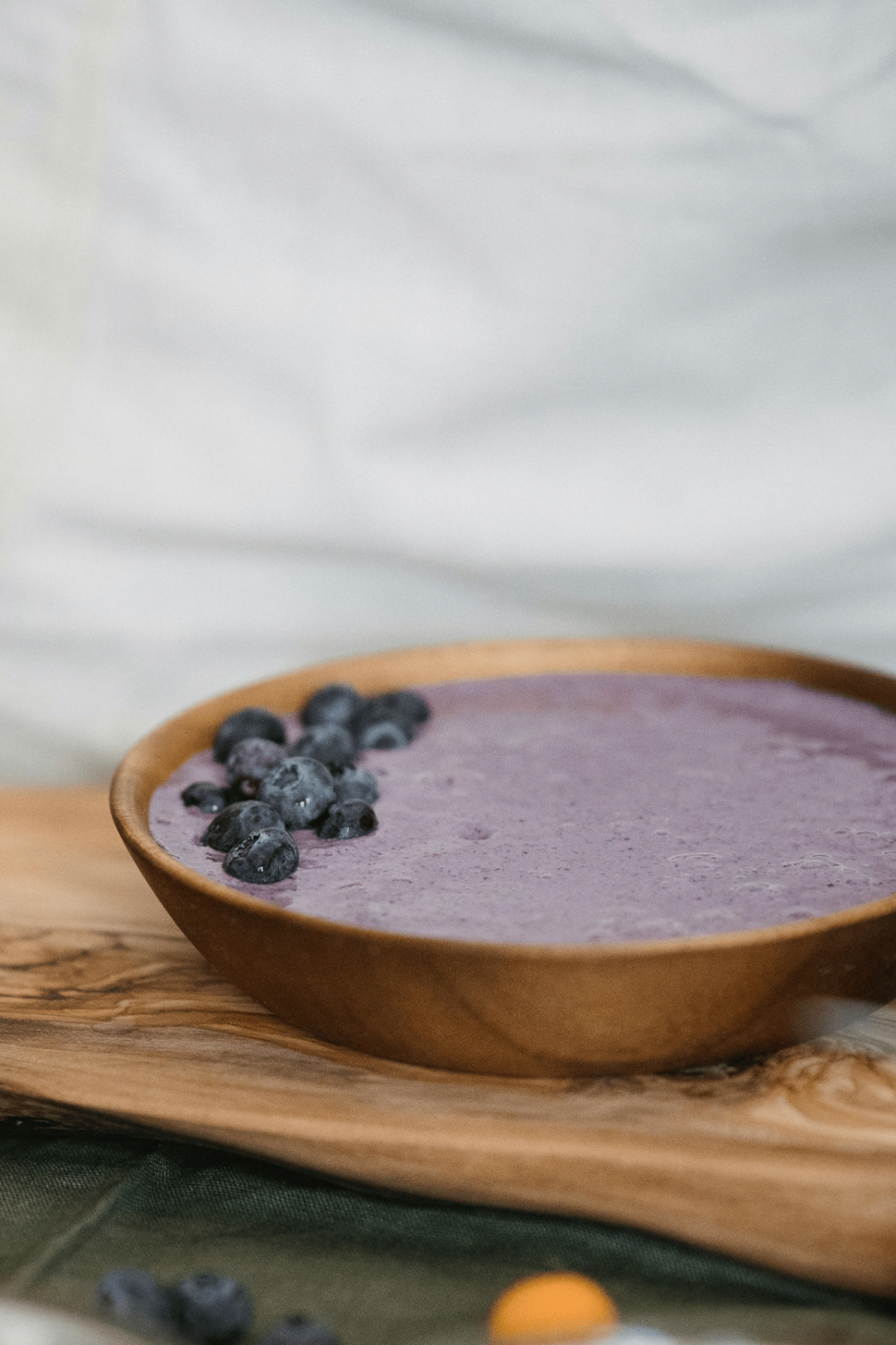 Thick blueberry smoothie with fresh berries for an antioxidant-packed breakfast.