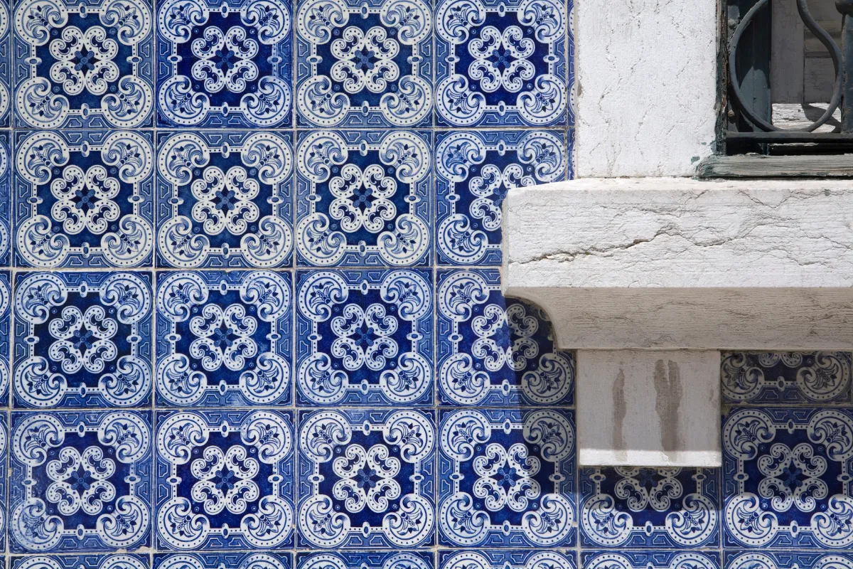 Close-up of ornate blue-and-white azulejo ceramic tiles adorning a historic Lisbon façade, Portugal.