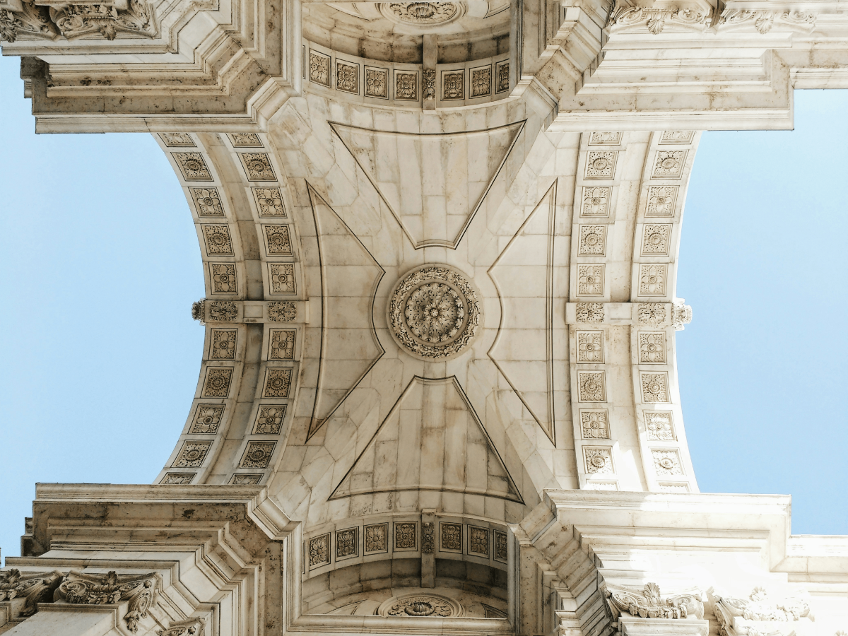 Intricate vaulted ceiling of Lisbon’s Rua Augusta Arch, showcasing neoclassical stonework in Portugal.