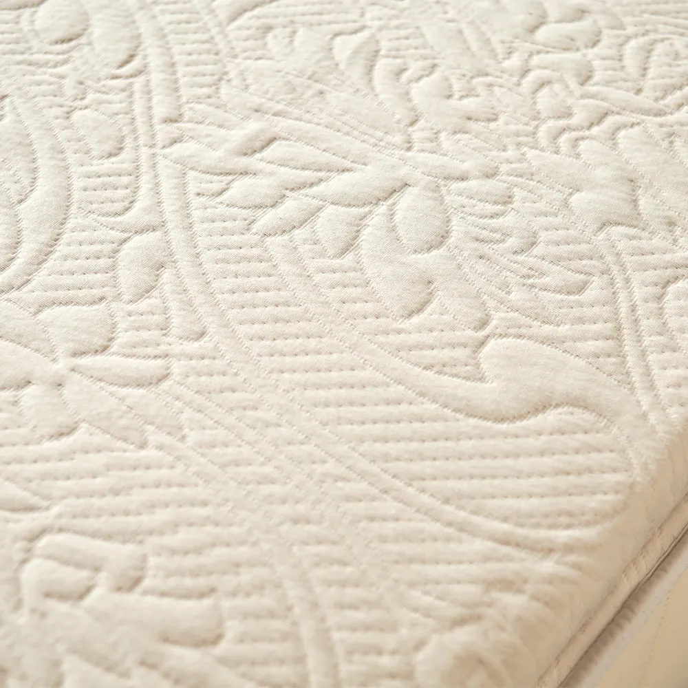 Embossed knit surface detail of Happsy organic latex mattress topper.