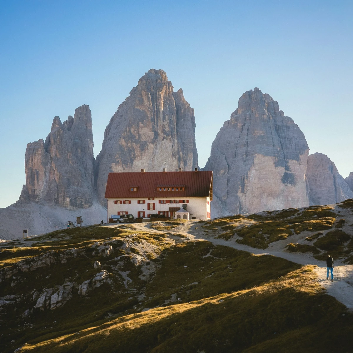 Rifugio Locatelli with Tre Cime di Lavaredo peaks rising behind in the Dolomites.