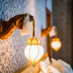Decorative lantern lighting and patterned walls inside Ca Maria Adele Venice suite interior
