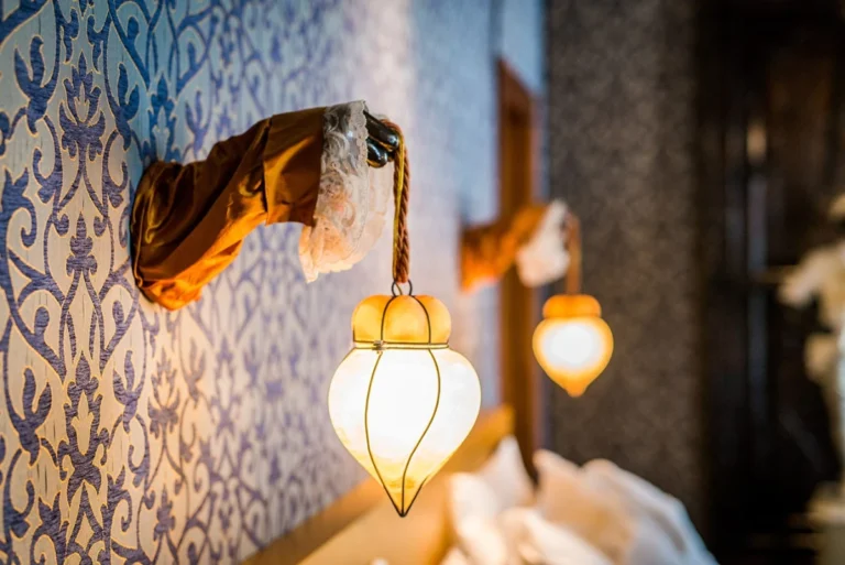 Decorative lantern lighting and patterned walls inside Ca Maria Adele Venice suite interior