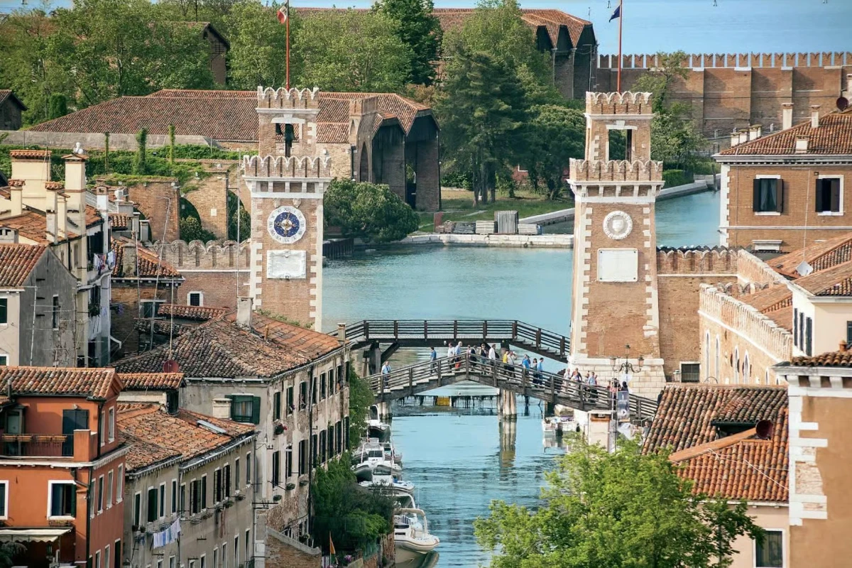 Brick bridges and narrow canals in Venice’s Castello district reflected in still water