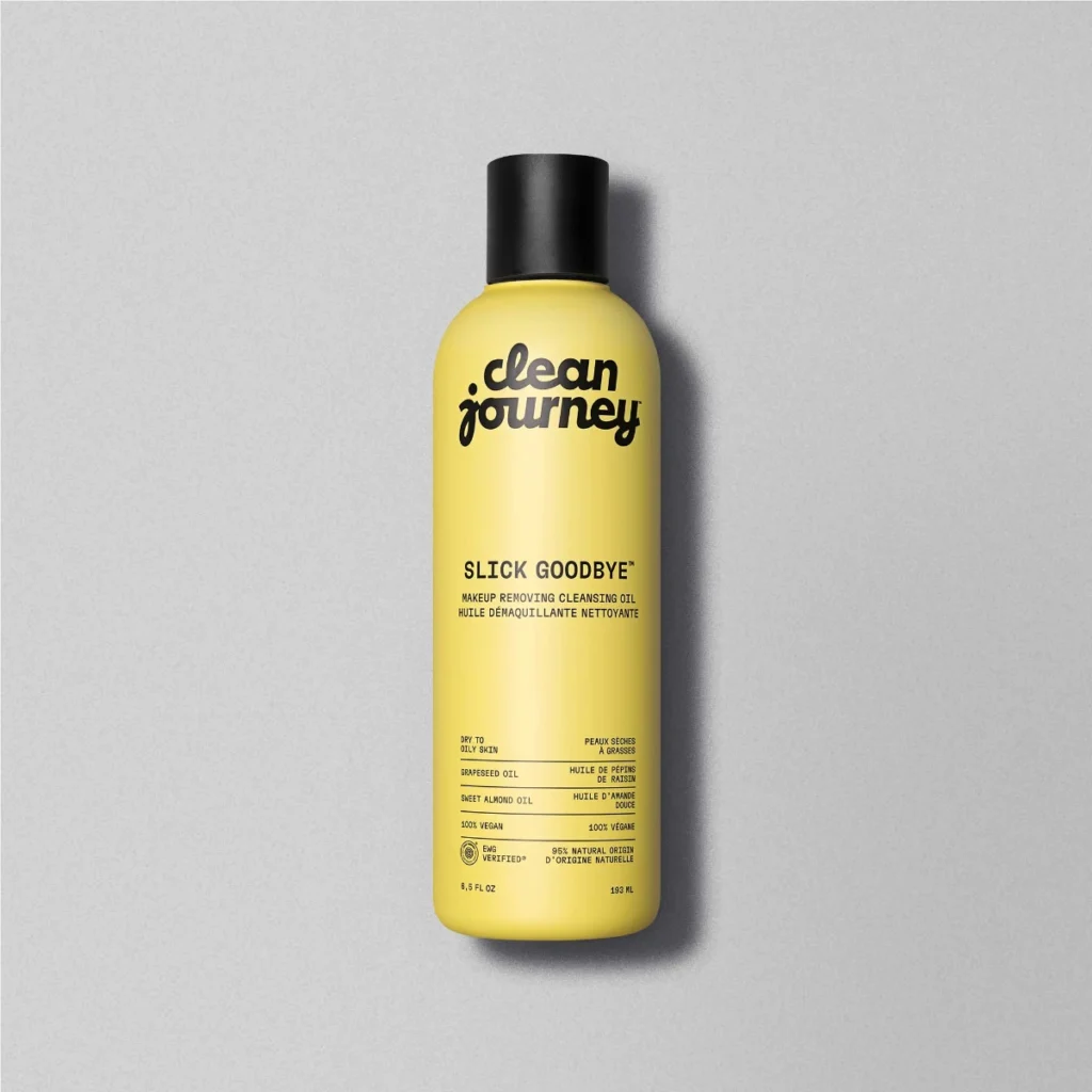 Clean Journey Slick Goodbye cleansing oil in yellow bottle against neutral background