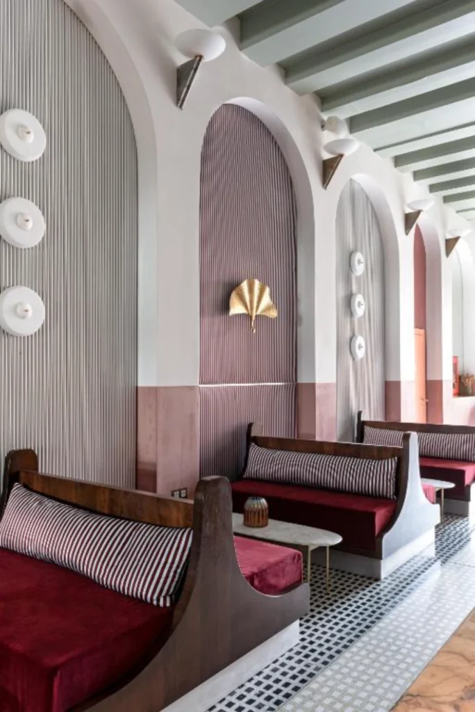 Striped banquette seating and arched interiors at Il Palazzo Experimental Venice restaurant