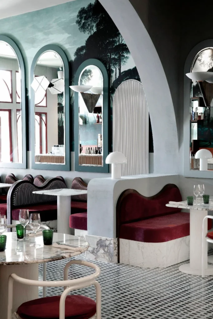 Art Deco-inspired dining room at Il Palazzo Experimental Venice with arched mirrors and marble tables