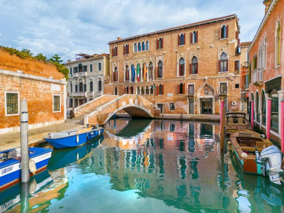 Canal and stone bridge in Santa Croce Venice lined with historic Venetian buildings