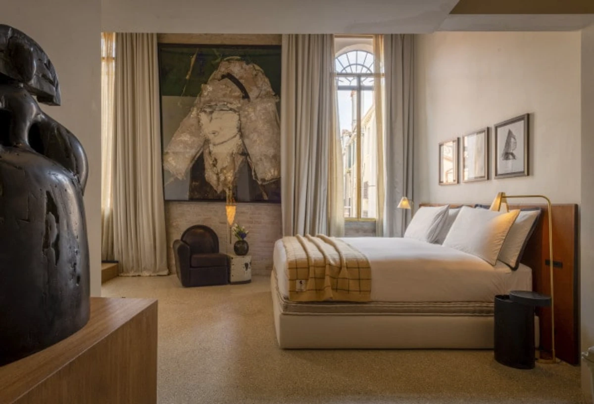 Elegant suite at The Venice Venice hotel with contemporary artwork and soft neutral interiors