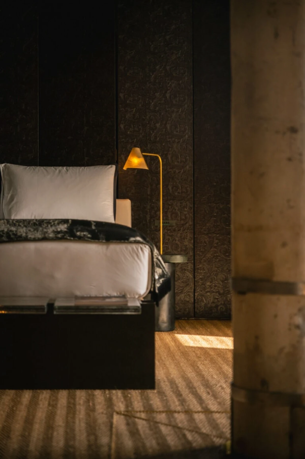 Moody contemporary suite at The Venice Venice with dark wood interiors and warm ambient lighting