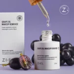 Ziel grape oil makeup remover with dropper and fresh grapes on lavender background