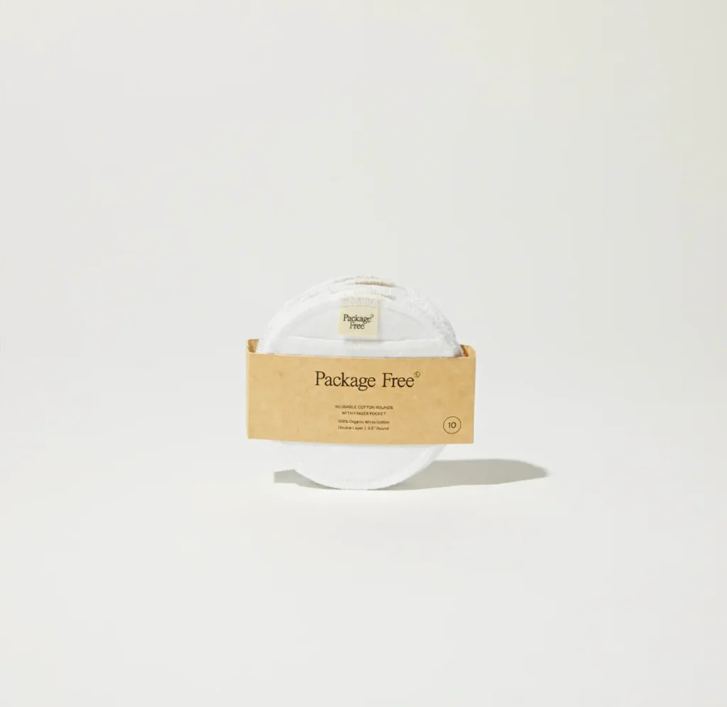 Package Free reusable cotton rounds bound with a kraft paper sleeve on a minimal white surface.