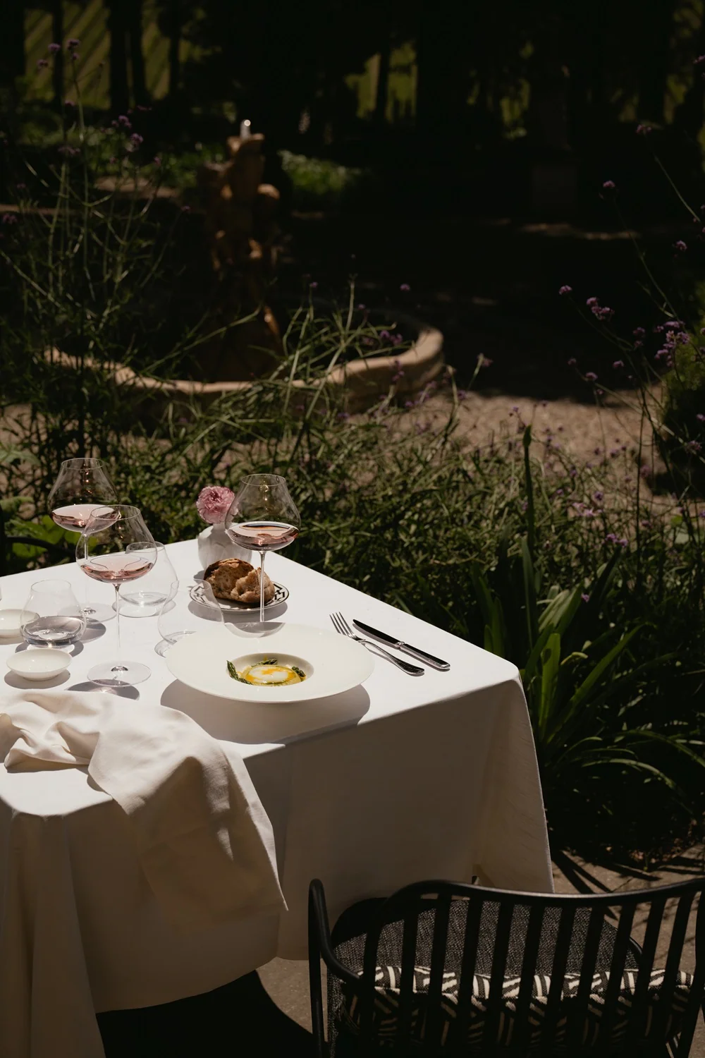 An intimate garden lunch at Limonaia Casa Ruffino, with rosé, warm bread, and an asparagus starter in dappled shade.